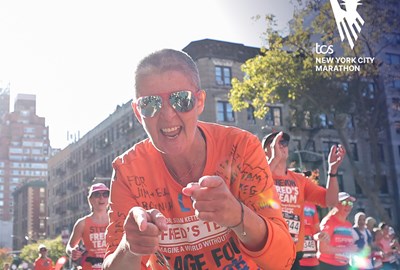 Liz Healy with sunglasses running the TCS NYC Marathon